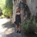 Naomi Loomis in fornt of a massive tree in Muir Woods