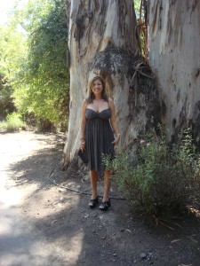 Naomi Loomis in fornt of a massive tree in Muir Woods